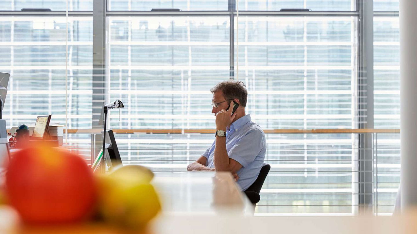 Employee talking on phone by computer