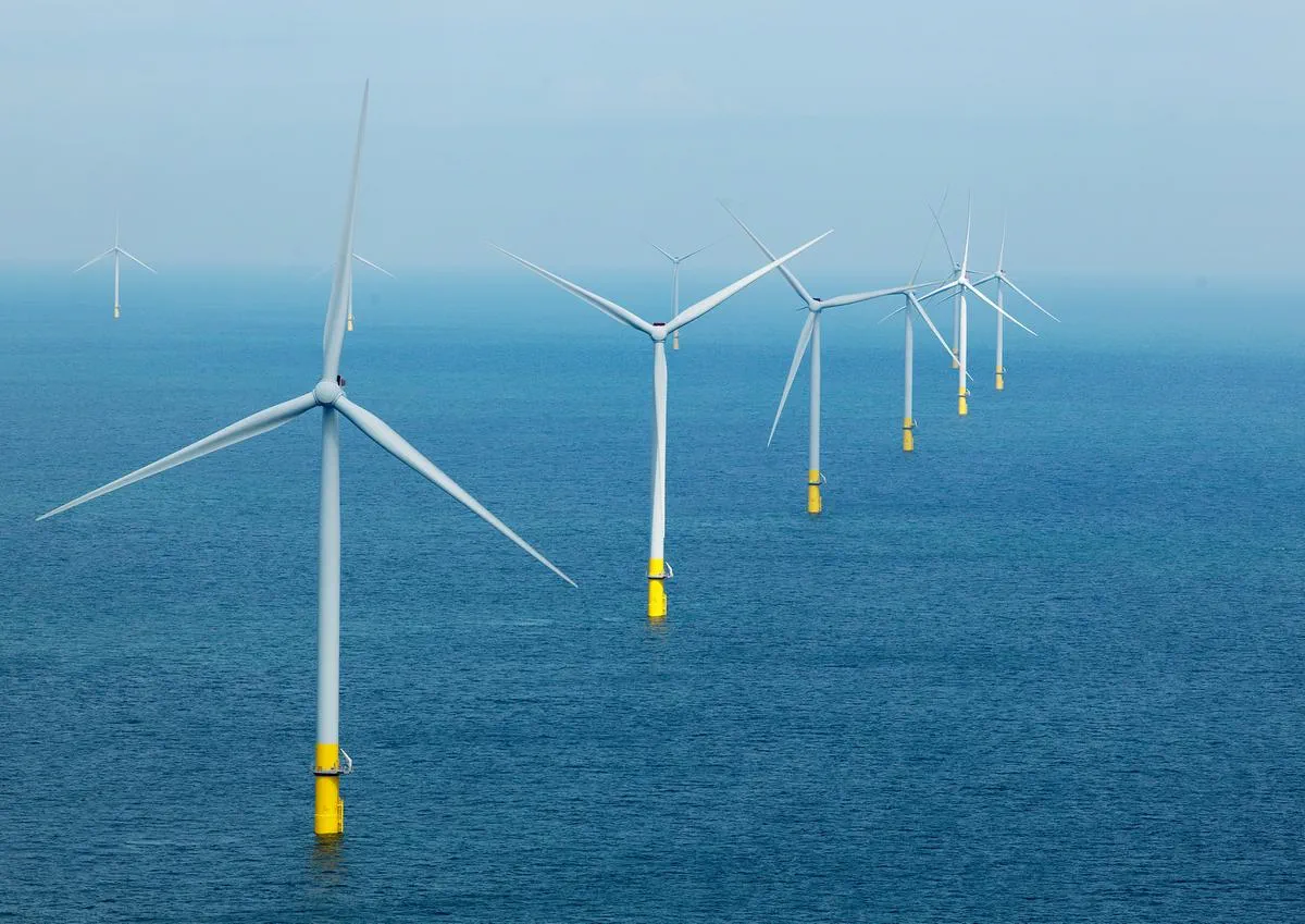 A line of ten offshore wind turbines.