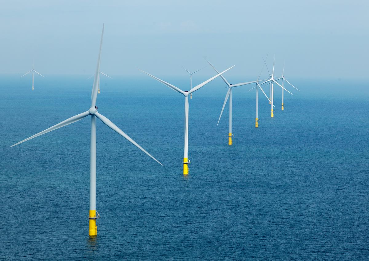 A line of ten offshore wind turbines.