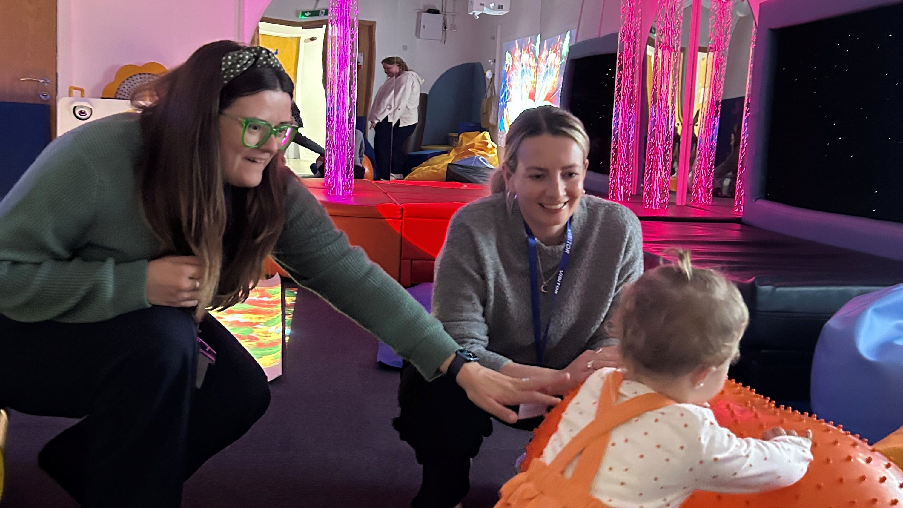 Charli Parkin and Lauren Little, Orsted, visiting Andy's sensory room with Adalee