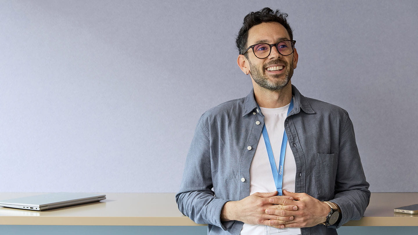 Portraits of employee standing by the desk, smiling