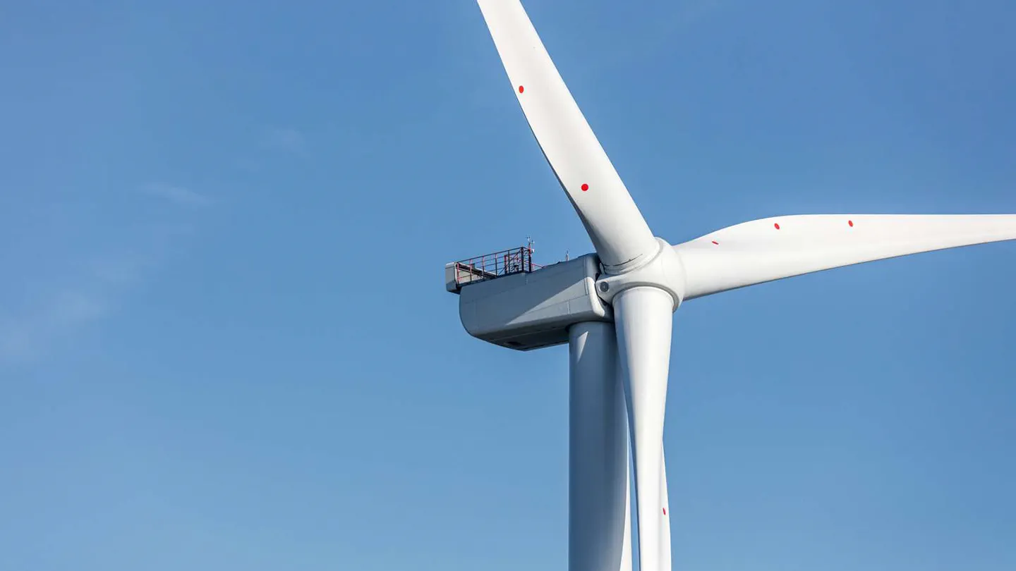 Wind turbine with a clear blue sky in the background