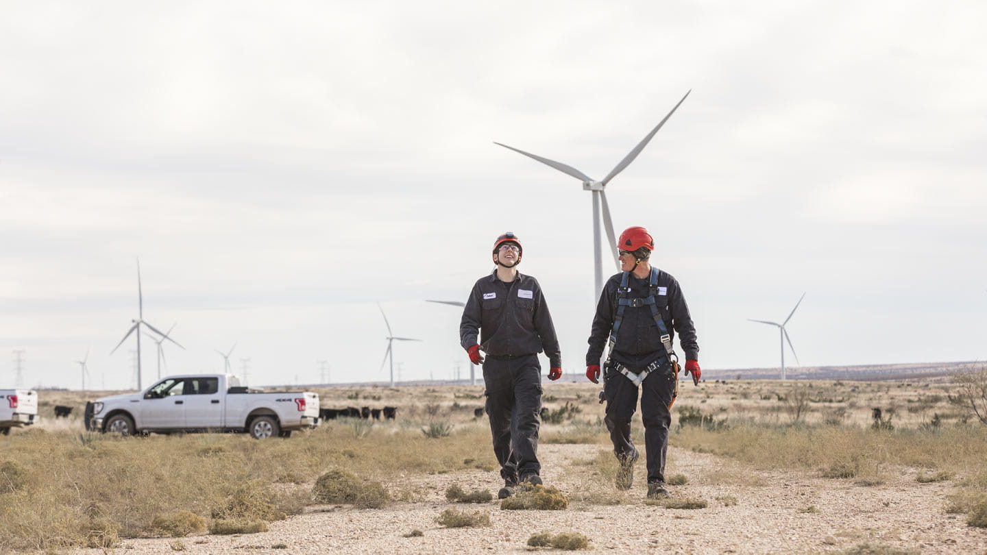 Two people by a windmill