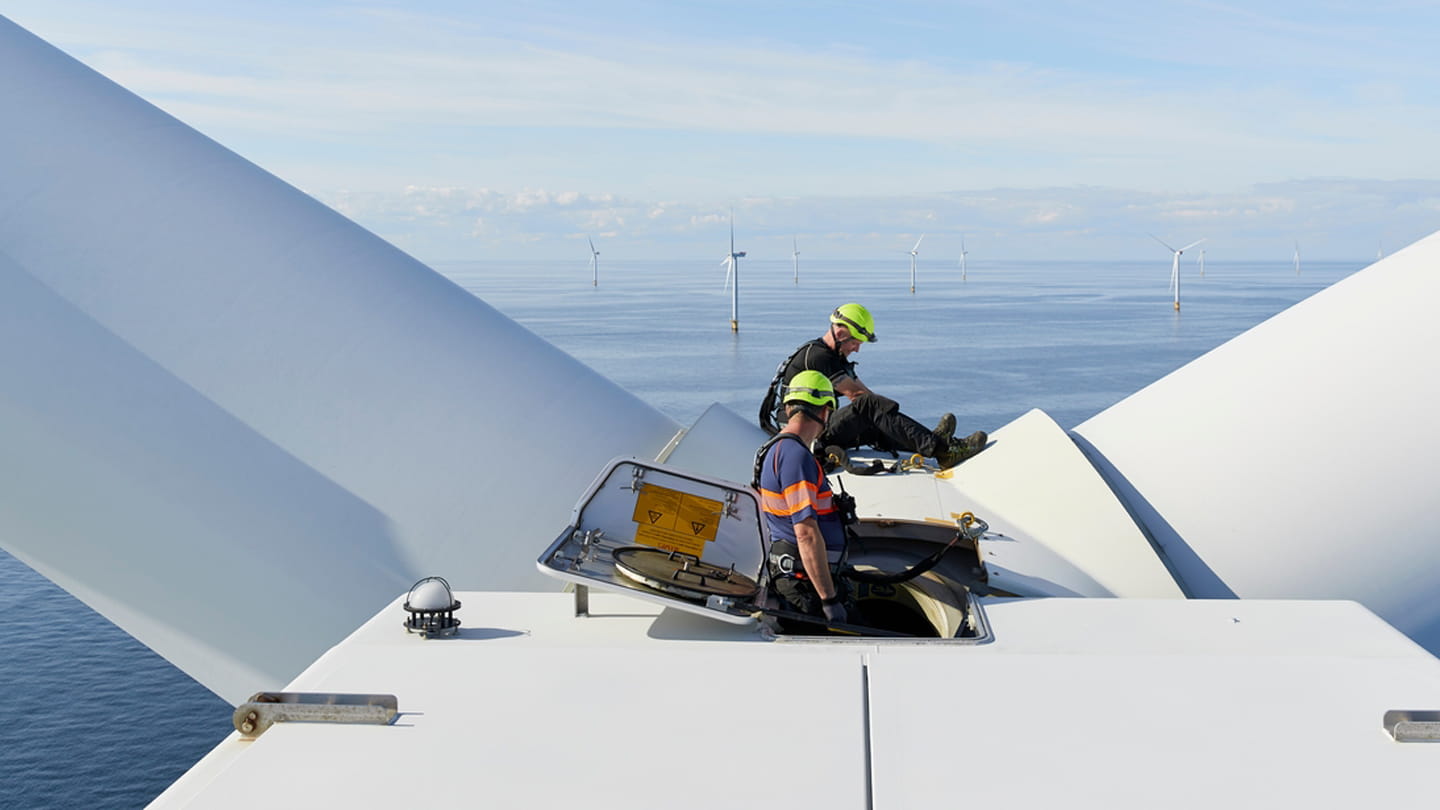 Technicians working top of an Ørsted turbine