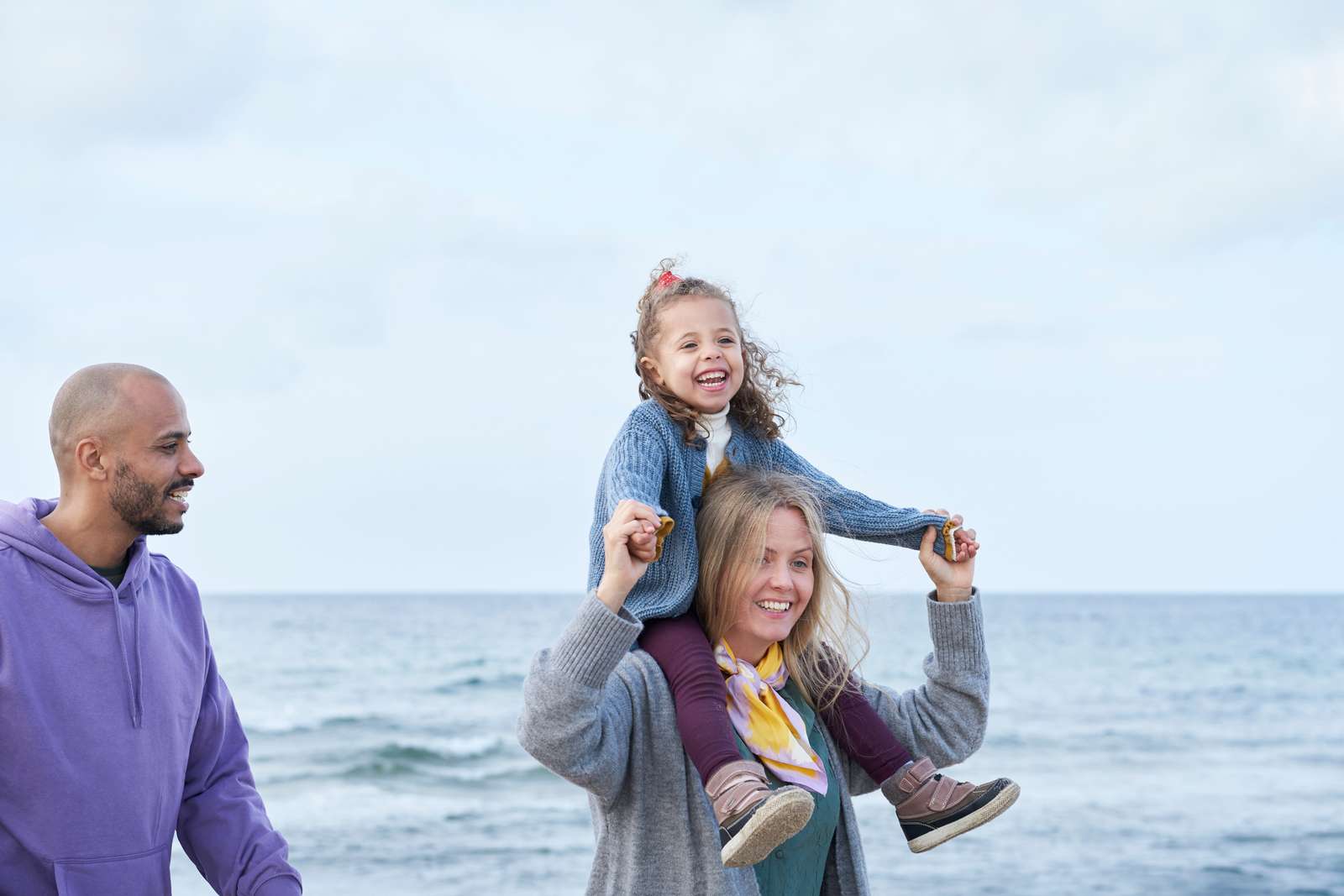 Image of family on the beach looking out to sea