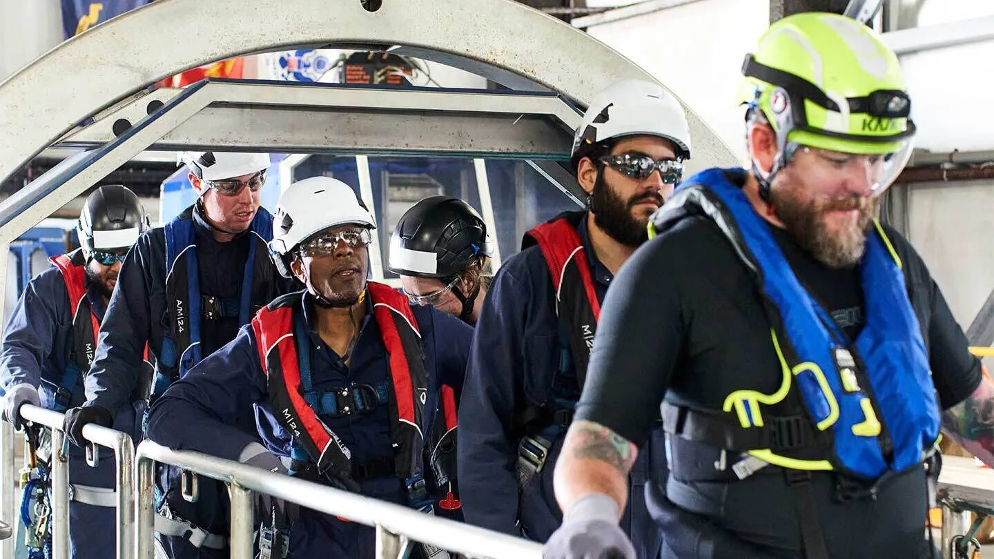 Ørsted workers wearing safety gear undergo safety training to prepare for offshore wind jobs