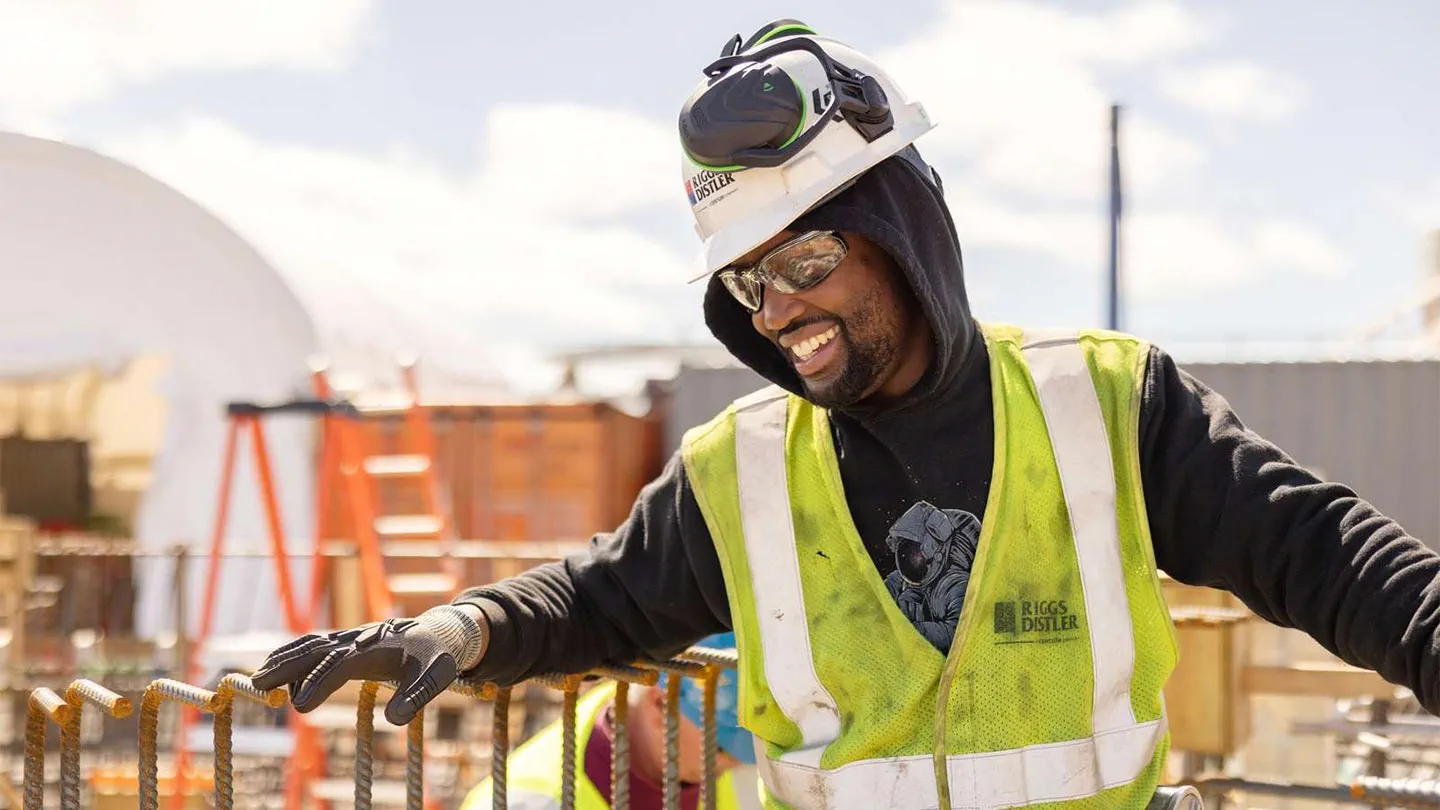 A young union worker reaches for building materials on an American offshore wind construction site
